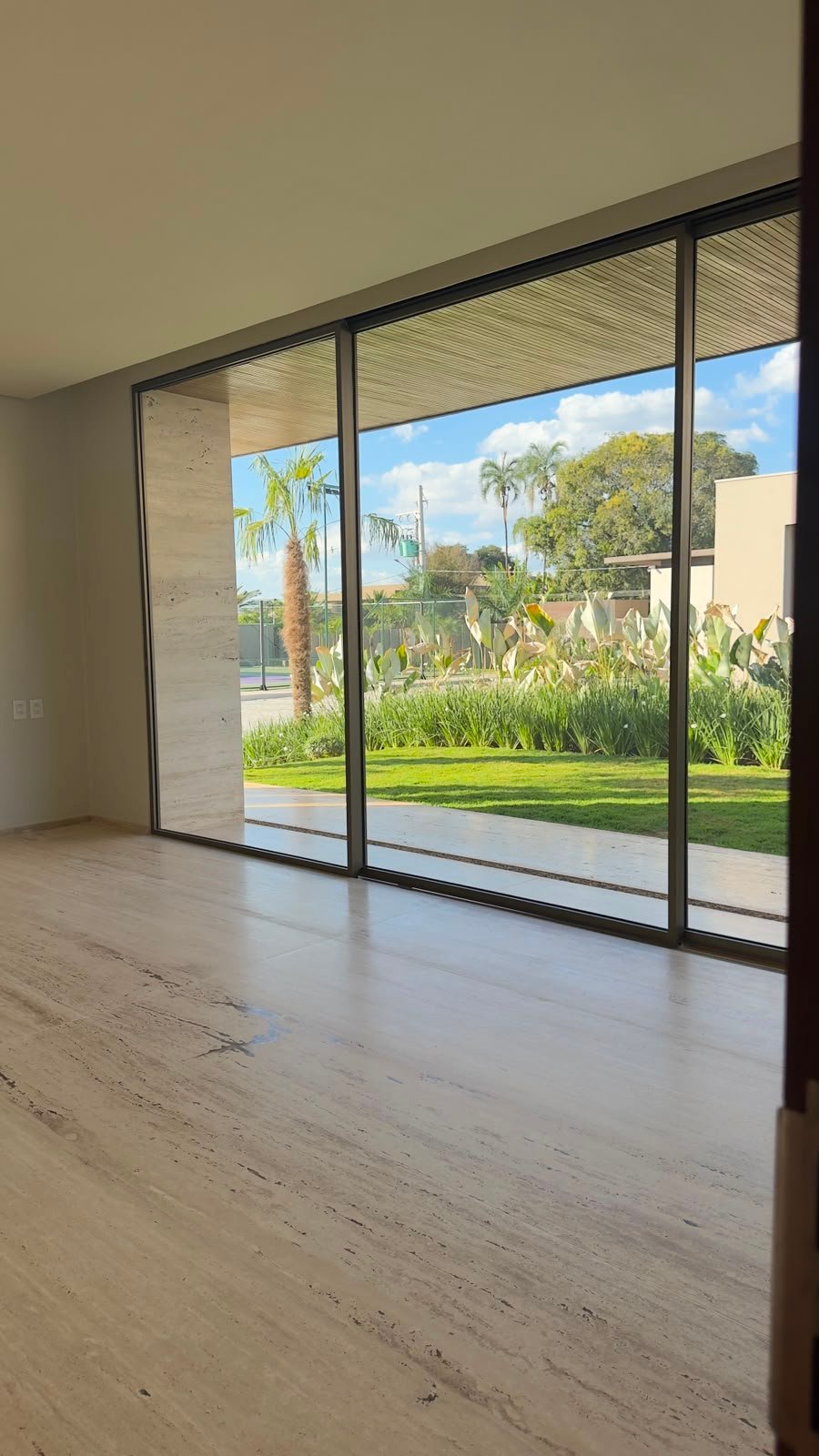 Sala integrada com esquadrias voltadas para o jardim